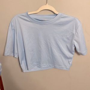 Light blue cropped tee.